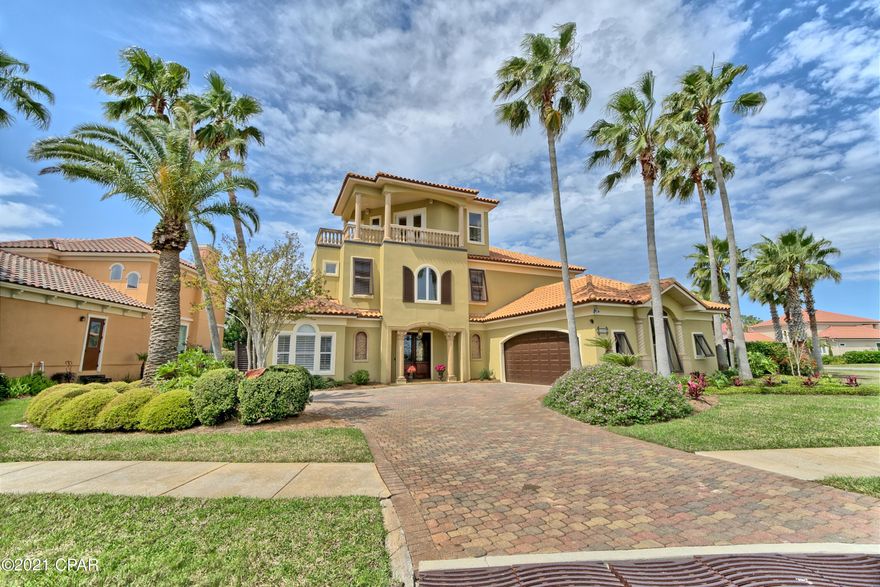 CURRENTLY UNDER CONTRACT, SELLER ACCEPTING BACKUP OFFERS Beautiful Mediterranean home located on two lots in the exclusive gated community of Finisterre! Located on the east end of Panama City Beach, this home features 4 bedrooms, 2.5 bathrooms, a bonus room and 3rd floor entertaining room with views of Grand Lagoon. The family room and kitchen offer a open floor plan with high ceilings and lots of windows for natural light. The oversized master suite is located on the first floor with a sitting area and large walk-in closet. The master bath offers double vanities, a jetted tub and separate shower. The remaining 3 bedrooms and bonus room are on the 2nd floor of the home and have a shared bathroom with a double vanity. The 3rd floor has a built in bar with a wine refrigerator, beautiful bui