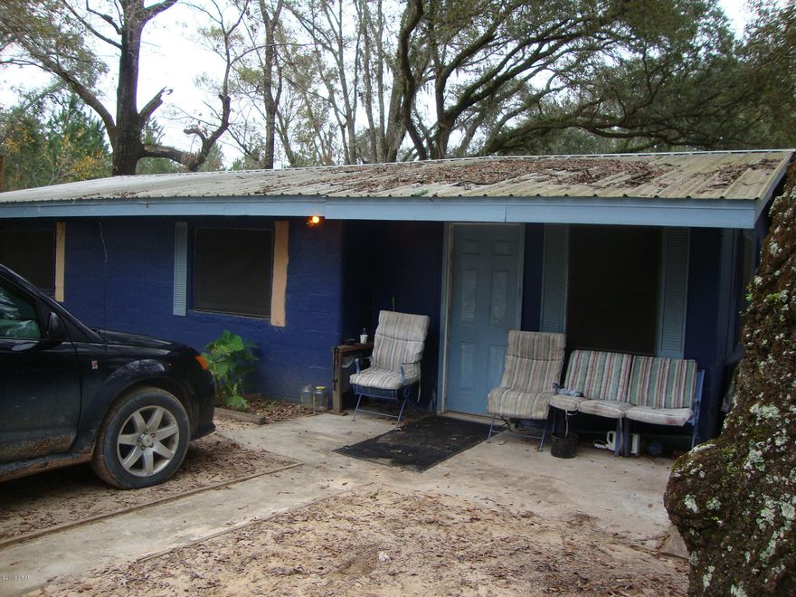 Handyman's Special is this 2 Bedroom 1 Bath Block home on 6 Acres. Has a metal roof, well and septic tank. House is livable and is rented but needs a lot of work.  Land is about half cleared and half wooded. Frontage on county maintained dirt road.  Fix and save.