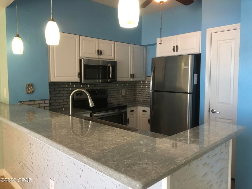 Price Reduction! Shores of Panama is a premier luxurious resort and one of the best ROI's on the beach! This is the most popular floor plan at Shores of Panama, with a double balcony and master bedroom facing the gulf! Lower floor  and one of the best views is the ''13th'' stack in this building, also comes with a primo dedicated parking spot on floor 3! This unit has all tile and LVT and has a brand new HVAC and water heater, also newer granite, vanties, and stainless appliances. Shores of Panama is a 23 story Tuscany style condominium complex in the heart of PCB, and right next door to world famous Pineapple Willys restaurant. Shores of Panama has unbeatable amenities, including a massive gulf side pool and hot -tub, 2 tiki bars, indoor pool, garage parking, and a fitness center