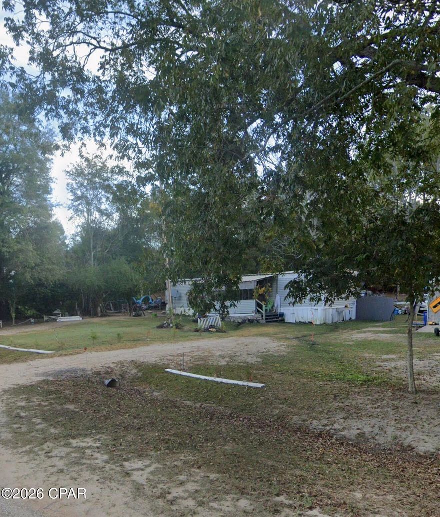 Situated on approximately half an acre across from beautiful rolling farmlands, this property offers a peaceful setting with plenty of potential. The existing mobile home it holds minimal value, making this an ideal opportunity for those looking for a land purchase, future homesite, investment property, or renovation project. Utilities are already in place, providing a head start for your vision. Enjoy the quiet country atmosphere while still being conveniently located near Bonifay and the FL/AL line. Property is being sold as-is and priced primarily for land value.