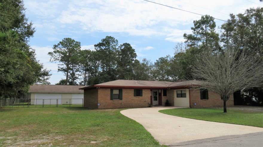 Well kept BRICK home w/HUGE SHOP in the Tyndall area.  This 3 bedroom, 2 baths home has a nice open living area and features a spacious dining area & large living room with brick fireplace flanked by built-in book cases.  The compact kitchen offers plenty of counter space and cabinets,breakfast bar and all appliances convey. The adjoining den could also serve as an office and you will love the huge laundry room with loads of built-in cabinets. The back yard is great for kids or pets or keeping boats or other toys out of sight. If you have always dreamed of having a big shop one day, then stop here! It is large enough to park 2 cars in one bay and and use the other 2 for hobbies and storage. This home is in excellent condition and could be awesome with your imagination and  some updating!