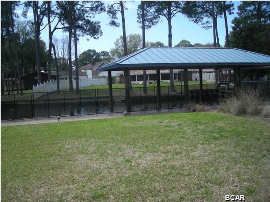 Bring your Boat to this Fabulous landscaped waterfront canal lot located just a couple minutes ride to the Bay and Gulf!  Lot has approximately $25k in custom landscaping and irrigation. Ready for you to build your dream home! Boathouse is equipped with electricity & water and can house a 30' plus boat. Gorgeous outside patio/kitchen area has pavers and a custom built stone gas fireplace. Protective fencing on wood deck/walkway and there is a well. Call today!