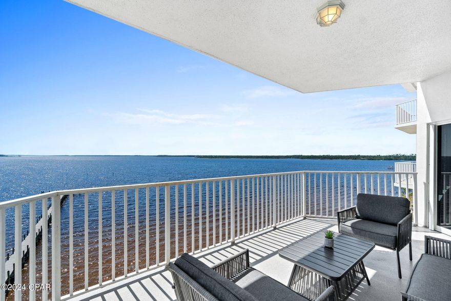 CURRENTLY UNDER CONTRACT.  SELLER WILL CONSIDER BACKUP OFFERS.  Come experience the amazing panoramic bay views and stunning sunsets from this spacious 6th floor condo.  There are numerous updates which include new kitchen cabinets, tile backsplash, LVP flooring throughout, updated modern light fixtures, to name a few.  Motorized smart window shades on windows in the living and dining area allow you to schedule when your shades come up and go down.  Smart lighting is installed in the kitchen, dining room, and on the balcony. 
 With 1525 sq. ft. this condo feels expansive and bright.  The large primary bedroom has a stunning bay view.  The large walk in closet features wood shelving.  There is a roomy walk in shower, whirlpool tub, and 2 separate vanities.  The laundry room offers lots of storage and is large enough for a desk or workbench.  The sizeable second bedroom is large enough to be used as another primary with access to the second bathroom.  The living/dining/kitchen is light and bright with stunning views of the bay.  Sit and relax on the balcony to enjoy the captivating sunsets.  The condo complex offers high speed internet, water, and cable t.v.  Amenities include heated pool, hot tub, fitness room, community room, private beach, and boardwalk.  There's one large, covered parking space reserved for the unit as well as outdoor parking for guests.