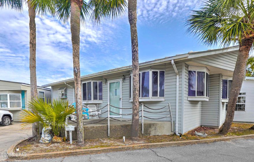 Check out this great 2 bedroom, 2 bath home on a wonderful corner lot!  Nice open floor plan with large rooms throughout. Extra living space could be used as a 3rd bedroom or bunkroom. You will love the large driveway with room for 2 cars and a golf cart! This beauty also has a nice porch with plenty of room for grilling and relaxing after a long day at the beach.  Make this your 2nd home, rental or become a local and join us in paradise living your best life here in Venture Out!   It doesn't get better than this! Venture Out is a golf cart community that has exploded with popularity recently... With 300' on the beautiful pristine beaches of the Gulf of Mexico and 1,000' on the Grand Lagoon. Venture Out has something for everyone. With 2 pools, fishing pier, boat ramp, mini golf, & more