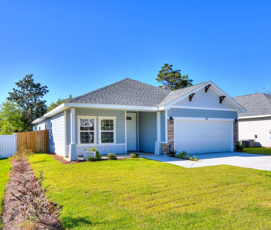 Beautiful new construction home. 1,785 Sq Ft of open floor plan living space with 3 BR's and 2.5 baths. Porcelain tile throughout for easy beach living. Custom Craftsman style, painted, shaker cabinets in kitchen and baths, granite counter tops and stainless steel appliances. The living room with trayed ceiling opens onto the covered patio and fenced back yard. Large master bedroom with luxurious tiled bath, double sink vanity, walk-in glass enclosed shower, soaking tub and huge walk-in closet. 2 additional guest bedrooms with Jack and Jill bath. This home checks off everything on the list with 9' ceilings, upgraded lighting, beautiful finishes, fully sodded yard with lush landscaping and 2 zone irrigation system and even hurricane fabric shutter.