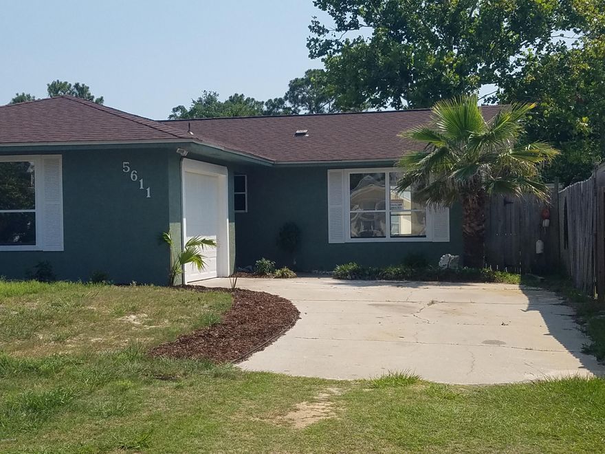 This COMPLETELY RENOVATED 2 bed, 2 bath Beach Home with an attached garage is less than 4 blocks to the beach.Features a Fenced Private Back Yard with a Large Storage Building, Covered Patio and Wood Deck.Large Laundry Room with plenty of space for storage. Open and airy Spacious Floor Plan, Cathedral Ceilings, Living/ Dining room and Kitchen with Breakfast Bar. New Paint inside and out, New Custom Cabinets and Granite Countertops in Kitchen and Bathrooms. New Appliances, Disposal, Sinks, Toilets and Faucets. New Tile Floor throughout,New Carpet in Bedrooms, all New Light Fixtures, Ceiling Fans, Trim and Doors. New Double Pane Windows New Everything! No HOA and Not in a Flood Zone. Come see this like New, Move in ready Beachhome that is within Walking distance to Beach and the Grand Lagoon