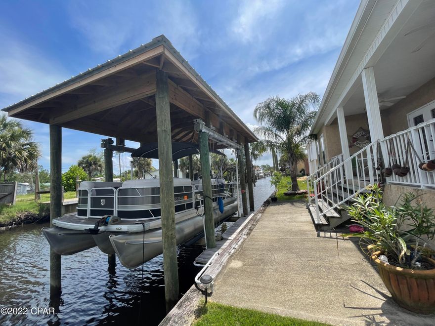 Immaculate 3 bedroom, 2 bath fully furnished waterfront home in the gated community of Harbour Towne! This beautifully appointed home is situated on a cul-de-sac style community with a canal allowing for boating access and includes a covered boat dock/slip! Centrally located on Panama City Beach just over the Hathaway Bridge with easy access to the East or West beaches. The home features all tile (wood-look) flooring throughout, an open concept kitchen, dining and living room, and a covered porch overlooking the water. The master bedroom has a queen bedroom suite, attached master bathroom with walk-in shower and soaking tub, and a walk-in closet. There are two additional bedrooms with full bedroom suites and a shared hall bathroom. The living room offers the coastal touch with its decor and custom shiplap. Rent includes lawn service, cable and trash. **Pets negotiable with $350 non-refundable pet fee.
