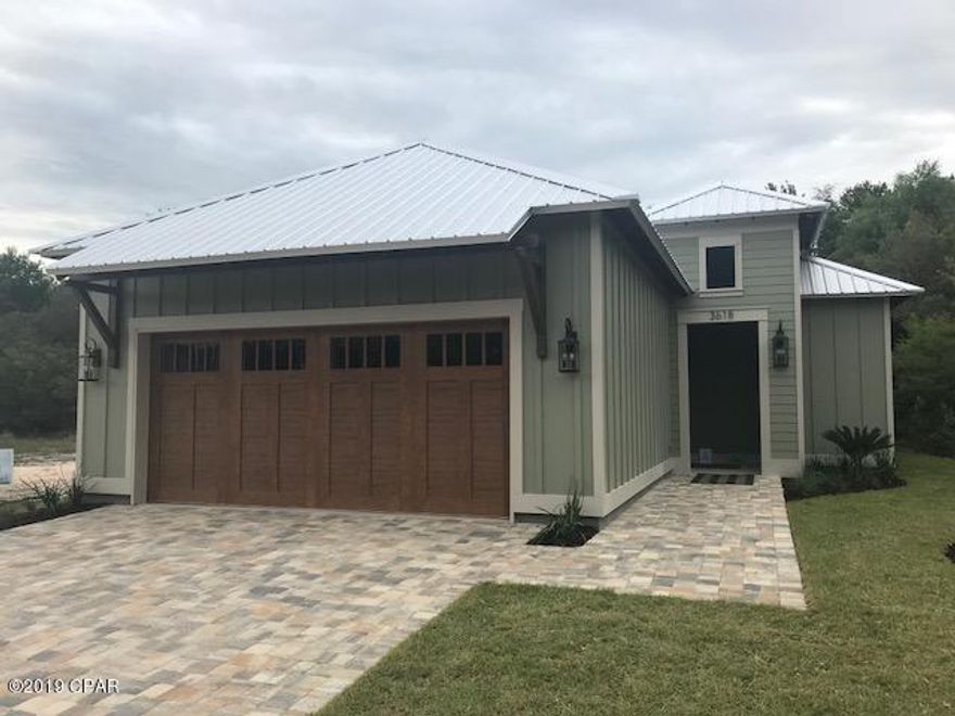 Welcome to the beautiful GATED Sanctuary Beach Subdivision - Tucked away between Bay Point and St. Andrew Bay - This is a BRAND NEW elegant single story CUSTOM BUILT home by Rick Koehnemann. This 3 bedroom, 2 bath home has qualities galore including 10' double trey ceilings that seamlessly flow through the kitchen and dining area and into the living room that leads to the double glass doors onto the 13'x18' screened porch with cathedral ceiling. The porch overlooks the oak tree shaded back yard! The kitchen features Craftsman Style cabinets with an island with complimentary colors and quartz countertops - self cleaning smooth top range, side by side refrigerator with bottom freezer. Beautiful engineered oak floors throughout the kitchen, dining, living and master br.