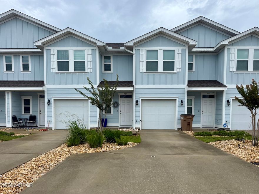 Welcome to your slice of coastal paradise at 7687 Shadow Lake Drive in beautiful Panama City Beach!  This charming 3-bedroom, 2.5-bath home, built in 2020, perfectly blends modern style with laid-back beach living. With nearly 1,500 square feet of thoughtfully designed space, you'll love the open-concept layout that's ideal for entertaining or simply relaxing after a day on the water.  The bright and airy kitchen features sleek finishes, ample cabinetry, and a spacious breakfast bar that flows seamlessly into the living and dining areas--perfect for hosting friends and family. Upstairs, the private primary suite offers a peaceful retreat, complete with a generous walk-in closet and en-suite bath. Two additional bedrooms provide flexibility for guests, a home office, or a growing family.  Step outside and enjoy your low-maintenance yard or take advantage of the community amenities, including a sparkling pool just steps away--perfect for cooling off on those warm Florida days.  Located just minutes from the world-famous sugar-white sands of Panama City Beach, dining, shopping, and entertainment, this home offers the perfect balance of convenience and coastal charm.  Contact your favorite Realtor to set up a showing today!