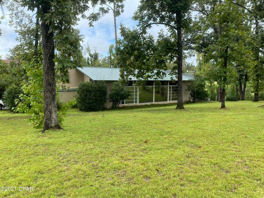 PROPERTY UNDER CONTRACT; SELLER ACCEPTING BACKUP OFFERS. A true mid century gem!! This home has all of the midcentury modern lines on the exterior and the interior. This is a 4 bedroom, 2 1/2 bathroom home in downtown Marianna. It features beautiful vaulted and beamed tongue and groove ceilings! The home has a lot of architectural elements that make it truly unique to its era of the 1950s. Currently the living room is being used as a large master bedroom. This room features floor to ceiling windows, a gas log fireplace and built in bookshelves. There is an additional den with a stone gas fireplace, spacious kitchen with dining room. Two of the bedrooms have a jack and jill bathroom between them. The master bedroom has en suite bathroom. The roof was replaced in 2019. There is an attached two car carport and spacious yard.
This home is located in close proximity to Jackson Hospital, Chipola College, Marianna K-8, MHS and the conveniences of downtown Marianna.