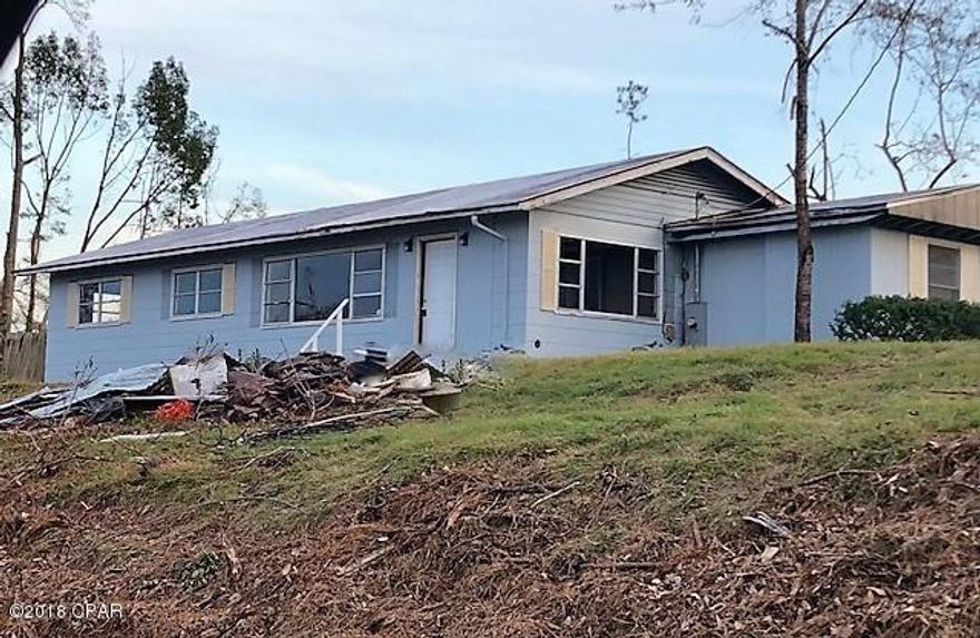 PRICE REDUCED!!      House in town on large corner lot.  It has a large living room, large kitchen and 3 bedrooms.  There is a den and large storage room that was added on the west end of the house.  It needs repairs and renovations but would make a good investment property.