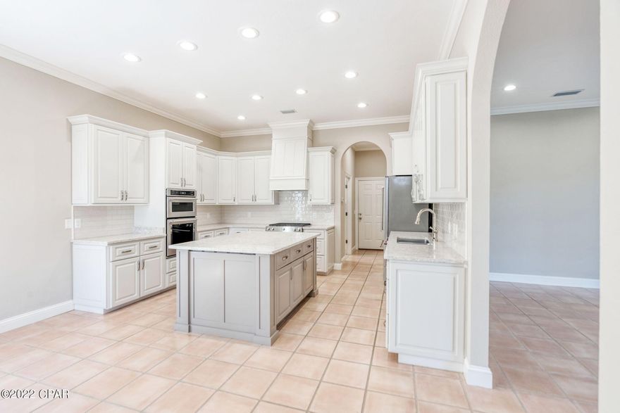 Elegantly designed waterfront home in the desirable Preserve on the Bay. The highlights are endless with views of the beautiful St. Andrews Bay, a newly stained dock with bay access on smaller watercraft, water views from the owner's suite, and stunning newly remodeled kitchen. Exterior also features screened pool, wet bar, spiral staircase leading to second level deck and access to a guest bathroom off pool. This home has a long list of improvements completed within the last 3 years, new interior & exterior paint, roof & gutters, all windows double-paned, full kitchen and bathroom renovations, new staircase, new hardwood and tile throughout. Swimming pool was resurfaced, new pavers and aluminum pool enclosure. The home is equipped with new hurricane shutters on north, east, & front door. Home measurements are estimated, buyer to verify if important.