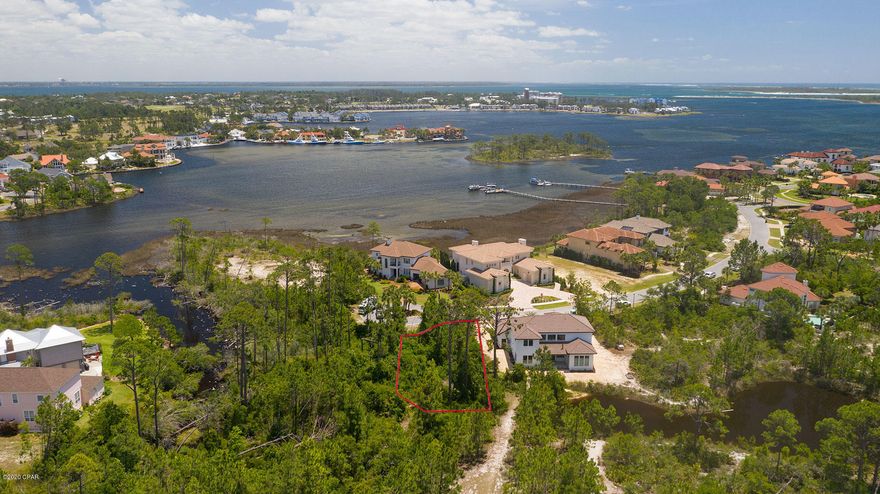 Large private lot in the exclusive gated community of Finisterre! This lot is located directly across the street from the water and will only have neighbors on one side. It backs up to a pond and land owned by the association that will not be developed. Build your dream home on a .19 acre lot located at the end of a cul-du-sac in this beautifully maintained neighborhood. Finisterre offers residents two tennis courts, a basketball court, playground and community dock. It is located walking distance to some of the best restaurants on Panama City Beach and minutes away from the worlds most beautiful beaches.