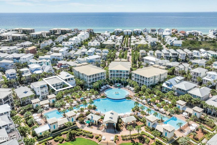 This spacious five-bed, four-bath beach house is superbly located overlooking the 12,000-sq.-ft. lagoon pool in the heart of Seacrest Beach. Set back behind palm trees, it enjoys its own privacy yet is just a stone's throw from the interconnected pools and fountains at this fun-filled oasis. From the coveted two-car garage on the first floor to the generous top-floor open terrace, this home was built for relaxing vacations and togetherness. With a little updating, this property could be a great investment for rental income or just to enjoy with family and friends. Balconies on the upper floors allow everyone to find their own quiet space. The second-floor has an inviting open kitchen, dining and sitting area for gathering around the TV for movie nights, board games or leisurely dining. Extra guests can be seated at the adjoining breakfast bar, perched at the kitchen island or dine outdoors on the balcony or patio. The kitchen is fully equipped for preparing meals and snacks for hungry diners after a fun-filled day at the pool or beach. Head to the third floor terrace for sunning, sunset drinks or stargazing in the gentle sea breeze. This beautiful private haven looks down on the surrounding community. Bedrooms include two master suites, one on the second floor with a private balcony and ensuite bathroom, and the other on the third-floor with ensuite bathroom and attached bunk room which leads out to a peaceful balcony overlooking the pool. An additional first-floor bunk room shares a Jack-and-Jill bathroom with another bedroom with both having pool views and private patio leading out to the pool area. This well-located home has ample parking on the paved driveway and in the two-car garage which also provides storage for beach chairs and pool toys. There's a paved patio for barbecues at the rear of the home. Conveniently close to deeded beach access and tram stops, this spacious residence is at the front of the development making walking or biking to the renowned shops and eateries along 30A a breeze. Enjoy walking paths throughout the neighborhood and designated green spaces for pets, bocce ball, reading, or play areas for children as well as outdoor entertainment, farmers markets, and many amenities at Alys and Rosemary Beaches. This home offers the perfect blend of luxury and convenience. Buyer should verify all data and dimensions if important.