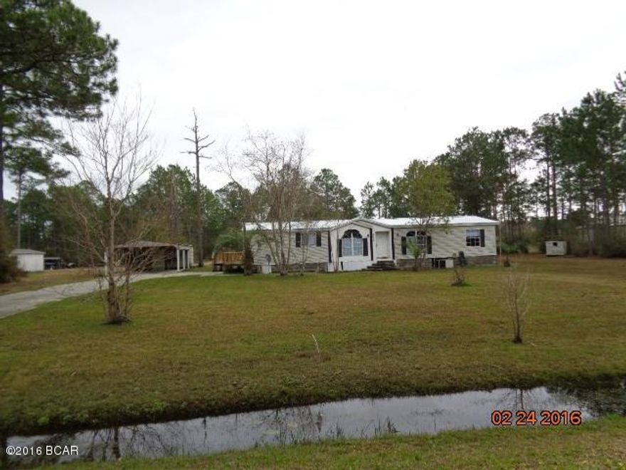 1993 DWMH IN GOOD CONDITION LOCATED ON 2 ACRES+- ON PAVED ROAD.  There is a detached 2 car carport with 12'x 20' shed attached to the carport. lots of open space and with a small fishing pond on the back of the property. Info from property appraiser website, Please verify if important. THIS IS A MUST SEE HOME. CALL FOR APPOINTMENT TODAY,