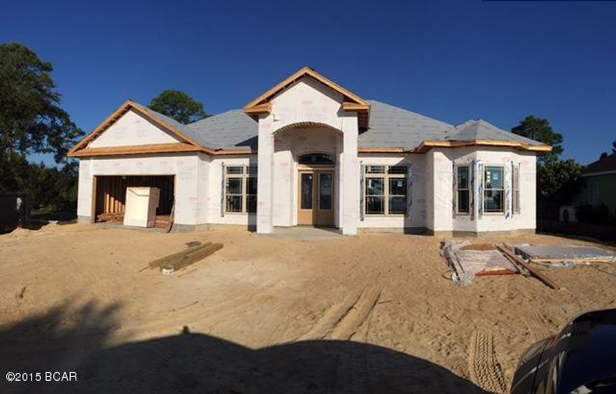 Quality new construction home,built by Bohn Construction. Located in the beautiful gated , waterfront community of Dolphin Bay. This spacious 2,603 square foot contemporary home has four bedrooms, three full baths and a formal dining room. This home features 10 and 12 ft ceilings, recessed lighting, crown molding, 20' tile and frize carpet. The well equipped kitchen boasts stainless appliances, solid wood cabinetry, granite counter tops, breakfast bar with pendant lights. The luxurious master bath features a large tiled shower, with frameless glass door, brushed nickel Delta fixtures, large tub, and double vanity with granite. Home will be fully sodded and landscaped, including an automatic sprinkler system. Dolphin Bay amenities include, boat ramp, marina, tennis courts,nature tails.agent trails. Dolphin Bay is conveniently located to the Hathaway Bridge, Thomas Drive Beaches and Pier Park shopping. Agent is related to the seller.