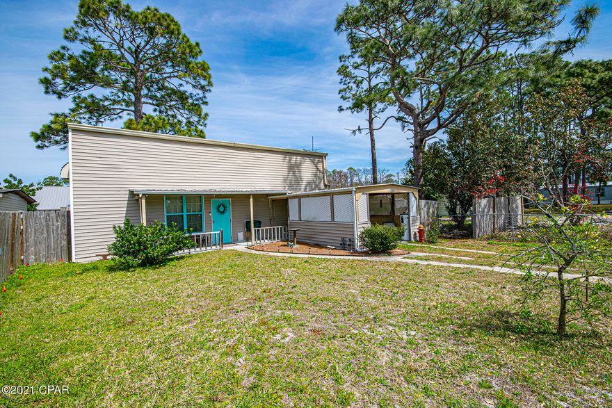 Unique Home located on Panama City Beach with 2 bedrooms,1 bath and bonus room.  Centrally located. Metal Building that was converted to house. Master bedroom with walk in closet and master bath downstairs and 2 rooms upstairs (1 with closet and 1 without). Wood Burning stove for heat and window air. HUGE attic space. Covered carport and fenced in yard.
