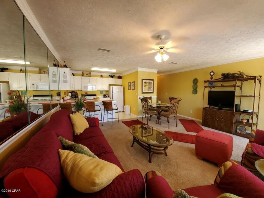 . Across the street from the beach and the beautiful white sand of the Emerald Coast and just 10 minutes from Destin's 30A. Newly decorated with reds and golds, tropical decor, this one-bedroom condominium is large with mirrored walls in living room, crown molding throughout. Dining area and breakfast bar. Full kitchen with adorable red small appliances, built-in microwave (new in 2017), dishwasher (new in 2018) & frig w/icemaker. Washer and dryer in the unit. Large front balcony. Large master bedroom (king-size bed) with private balcony, large closet. Queen sized sleeper sofa in living room, and also has a bunk in the hallway.  Association dues include cable, internet, water and insurance (except for contents), exterior upkeep. Outsi You will not find another condominium this convenient to shopping, grocery stores, airport, Pier Park, sports complex and entertainment. Less than a half mile from Highway 79, easy access. Wendwood Condominiums have a quiet family atmosphere, private pool, clubhouse, shuffleboard and tennis courts and ample parking. Unit shows pride of ownership and is extremely clean and beautiful.  It's been a great investment, it's a rental machine!   ****This is the only unit available in Wendwood.  They sell fast. **** OWNER IS FLORIDA LICENSED REALTOR.