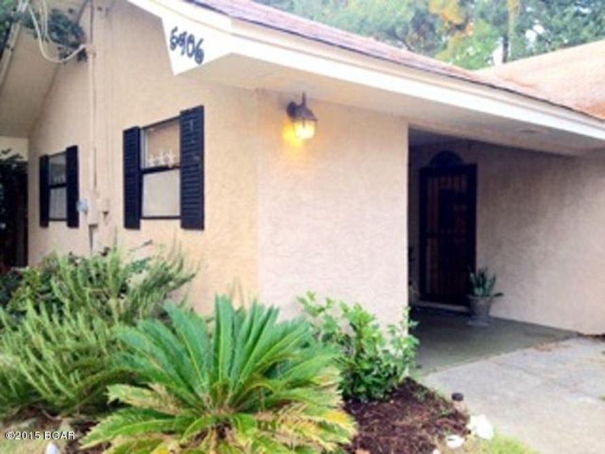 This 2 bedroom, 2 bath home is conveniently located off Thomas Drive. Walk to the beach or put your boat in at the public dock one block away. The spacious living area features travertine tile flooring, cathedral ceiling, and stained glass accent panels. The open kitchen features a breakfast bar, new dishwasher, and full size pantry. The master bedroom has carpet flooring, walk-in closet, and adjoining bathroom. The guest bedroom across the hall also has carpet flooring and a spacious closet. All new custom fitted tortoise wood blinds throughout. The separate bonus room is located off the carport and would be the perfect spot for a home office or recreation room. Heated outdoor shower. The fenced backyard has lush landscaping, wooden deck, and concrete patio set.