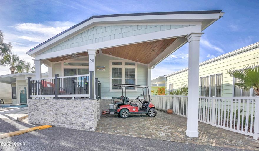 Welcome to your slice of paradise! This beautiful 2-bedroom, 2-bath beach cottage offers the perfect blend of coastal style and modern comfort, located just steps from the Gulf of Mexico and Grand Lagoon. Step inside to find a bright, open living area filled with natural light, vaulted ceilings, and coastal-inspired finishes throughout. The spacious kitchen features custom wood cabinetry, stainless steel appliances, and gorgeous countertops with a large island—perfect for entertaining or casual dining.  The primary suite offers a relaxing retreat with an ensuite bath and plenty of storage, while the second bedroom is ideal for guests or family.
Enjoy your morning coffee or evening breeze on the covered front porch with tongue-and-groove wood ceiling and park your golf cart & car under the covered carport with stylish paver driveway. This home's exterior is equally impressive with stone accents, vinyl siding, and a raised foundation for peace of mind and durability. Possible seller financing! Located in the highly desirable Venture Out Resort, a gated golf cart community with 300 feet of private beach access on the Gulf, 1,000 feet on Grand Lagoon, two pools, tennis courts, boat launch, and more! Located in gated resort with amazing amenities! Come live the beach life you've always dreamed of — schedule your private tour today!