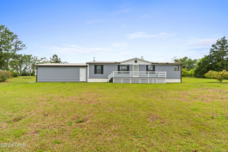 CURRENTLY UNDER CONTRACT, SELLER WILL CONSIDER BACKUP OFFERS Check out this affordable 3 bedroom, 2 bath home with 6.5 acres of land only 5 minutes from I-10 and 45 minutes from Panama City Beach. This great home features almost 1000 ft along Pate Pond Rd, a garage/shop plus a shed, a nice front porch, and plenty of space for gardening or to build another house. The interior features a split bedroom with floor plan with a huge living room, separate dining area, large master bedroom with double closets and en suite bath complete with tub/shower combo and a large vanity. This home has been well taken care of. Call your Realtor today to check out this great home with tons of possibilities.