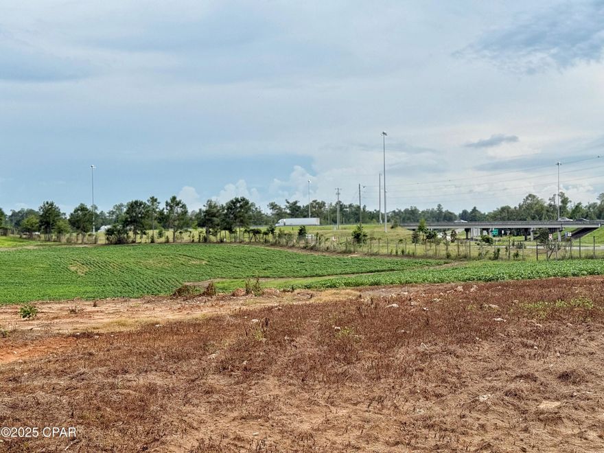 Prime property located on I-10 Exit 152 and Hwy 69 in Northwest Florida between Tallahassee and Pensacola, Fl.  This 30.43 acre tract has visibility from Interstate 10 being located immediately on the North East side of the Interstate.  It is currently in row crop with tons of potential for future.  Public water currently available to the parcel directly N of this parcel with sewer to be available in the near future.  There is a well and power pole existing on the property. Some of the property is located in the City of Grand Ridge and some located in the County of Jackson. Endless development possibilities! Currently zoned residential and light industrial.