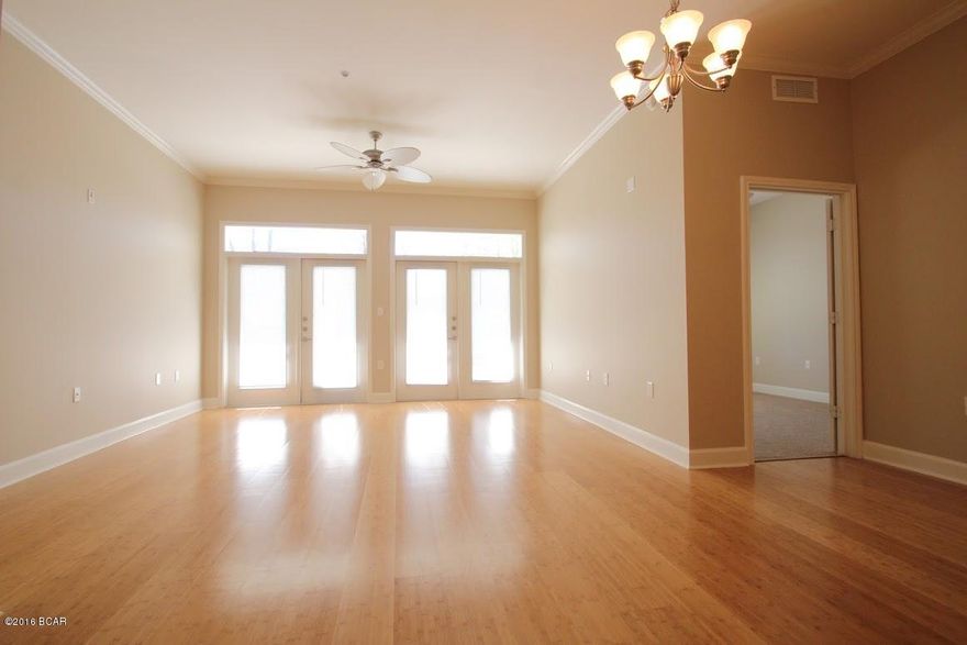 Ground floor unit at beautiful Island Reserve. The unit features 10 ft. ceilings with crown molding, granite counter tops and stainless steel appliances, bamboo flooring in living/dining room, carpeted bedrooms and tile flooring in the kitchen, foyer and baths.  The grounds have sought after amenities with tropical landscaping, one acre resort style lagoon pool with rock waterfall, game room, theater room, basketball court and fitness center.  Conveniently located to shopping, restaurants and the beautiful beach.  Age, sq. ft. and room sizes are approximate. Please verify if important.