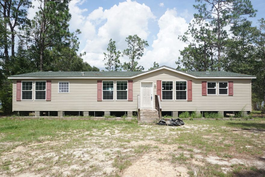 WATERFRONT home in gated Leisure Lakes community. This is a new construction, spacious, double wide mobile home on beautiful Open Lake, a pristine, spring fed, North Florida Lake. The home has a large master bedroom with glass doors that lead to open deck overlooking the lake. The master bathroom features large walk-in shower, double vanity, and large cabinet that serves dual purpose as storage and toilet privacy. The kitchen has large breakfast bar island, the second full bathroom has jetted tub and separate shower. There is also a generous screened in back deck overlooking the lake. Leisure Lakes is located about 30 miles North of Panama City and offers access to two lakes, a recreation area with boat ramp, dock, swimming pool, picnic area, playground, basketball and tennis courts.