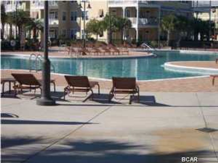 $155,000 BEAUTIFUL upscale FURNISHED UNIT!! YOU WILL FEEL LIKE YOU ARE LIVING IN A RESORT...PERHAPS LARGEST POOL IN BAY COUNTY (1 acre) w/ two waterfalls, SPLASH PAD and spa plus numerous seating arrangements for your poolside entertaining... all on one level AND ELEVATORS AVAILABLE IN THE BUILDING. This 2 bed 2 and a half bath unit is being sold FULLY FURNISHED!! This unit consists of a wonderful, spacious Open Floor plan,There are floor to 10ft ceiling windows in the living room. Bamboo Floors and Granite Countertops throughout along with Stainless appliances make this hard to resist. Split floorplan has 2 Master Suites (both with queen sized beds) and each bedroom has a door to the large ground floor private patio overlooking the back close to the 1 acre pool. The state of the
