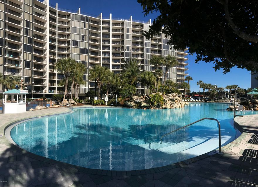 Condo For Sale with a Beachfront Master Bedroom! Spacious and inviting with a breezy balcony that promises an endless seascape of water, sand and sunsets. Furnished and already on a rental program to offset ownership costs. Enjoy large lagoon and tropical heated pools. Soak in a hot tub or relax on a sun deck. Relish a restaurant with good food (room service!), pizza shop, market. Unlimited Golf at the course just across the walkover! Sports Club features pro shop, gym, tennis, basketball, shuffleboard. Spa services available. Kids Club keeps them happy with splash pad, climb course, dive-in movies, activities calendar, special events. Owner's Pets Welcome! RV, boat, jet ski, electric car  parking. Secure, gated entrances. Walkable to shopping, dining, entertainment. Trolley to Pier Park.