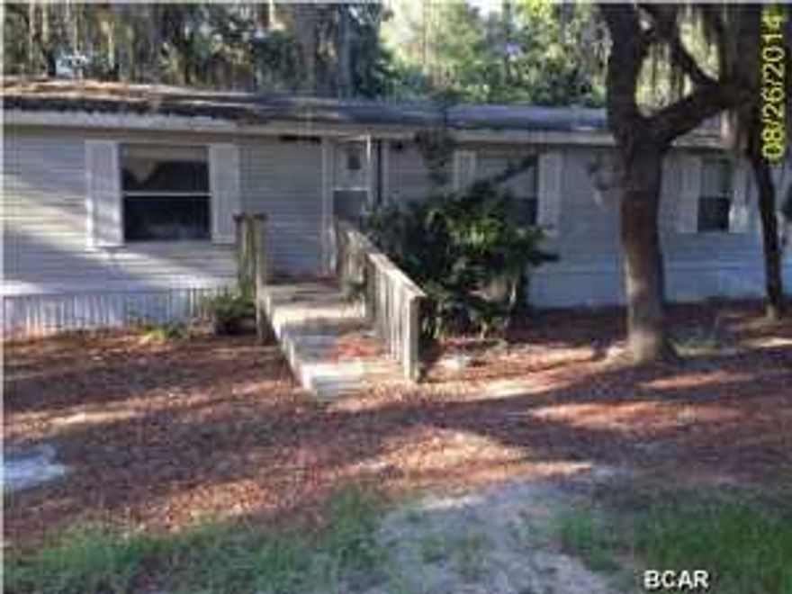 Awesome opportunity to own in the Santa Rosa community This is a 3 bedroom 2 bath mobile home on a beautiful corner lot. There is a huge screened in porch on the home. With a little TLC this would make a nice home or rental.