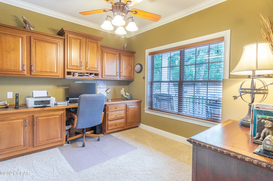 CURRENTLY UNDER CONTRACT, SELLER ACCEPTING BACK-UP OFFERS. Custom built home with 5966 sq.ft. under roof in a beautiful setting on Gap Lake with paved road access. Sun rises from the 2nd story deck and sunroom are radiant and awesome!  Pier with 24x28 covered boat dock & slip (electric lift). Floors are hardwood in the foyer, dining & living room, which features a gas fireplace. An island with a bar for eating in the kitchen, cherry cabinets, tiled floors as well as in breakfast room & sun room. There are three bedrooms downstairs with the Master BR facing the lake, and a bonus room upstairs with half bath. An office is off the foyer and a second office space in the laundry room.  There is a tiled deck in back with outside stairs to an 892 sq ft walk-out basement below. The 2 car garage and basement each have 200 amp service. The oversized garage has wide built-in shelving for storage and space for a large tool chest. The community boasts a popular 18 hole golf course that is well-kept and located about 2 miles from this property.  Boat lake is great for swimming.  Fishing is Free and  Unlimited in the area due to the many lakes in Washington County. Sunny Hills has it's own Library and a reception hall that may be rented.  Panama City Beaches and an International Airport are about 45min away. This home has been well maintained and move in ready!