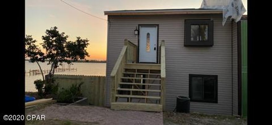 JUST REDUCED !! Bring you finishing skills and complete this great end unit Townhome located on the water, near Tyndall Air Force Base. This home has Beautiful water views from 3 floors, this home has an open floor plan and features 3bedroom and 2 1/2 baths, rock fireplace,  new decks, new sheetrock, new roof and new siding. This home has a detached 2 car garage. This end unit townhouse has so much potential. Tie your boat up to the New Dock. Close to Tyndall and Eastern Shipbuilders.  Call your agent and make plans to visit this waterfront townhome. If measurements are important please verify.