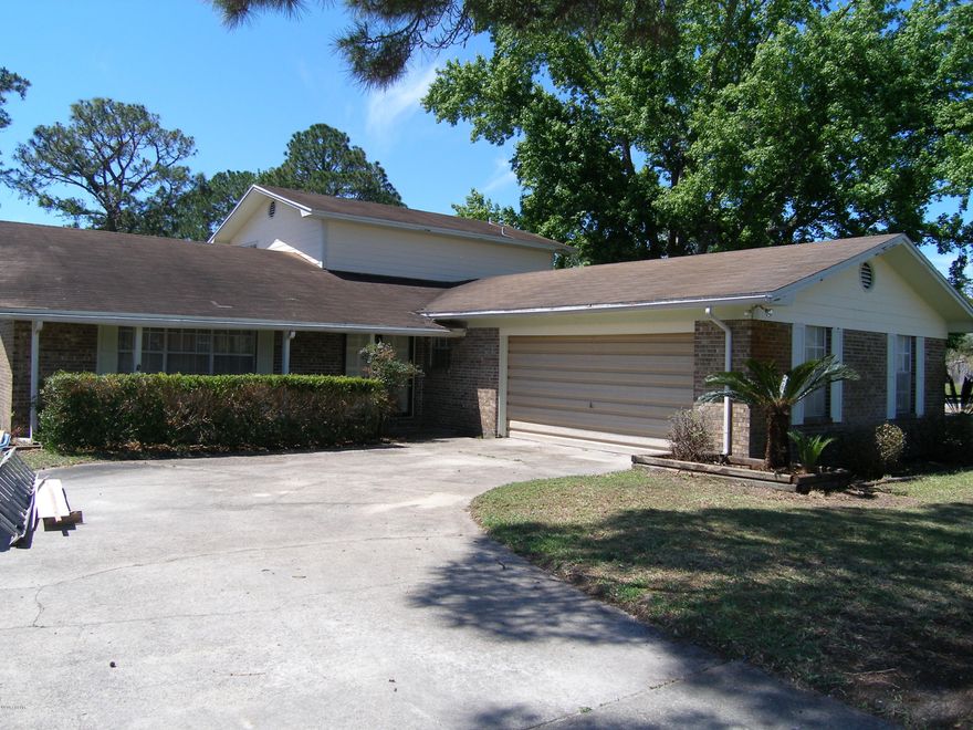 Waterfront-Pool-Lynn Haven-4 bedrooms-2 bath two story - 2500 sq ft. +/- This home has lots of things you may want...large in-ground pool, canal waterfront with boat dock, boat house and lift, large back and side yard, outdoor yard building, 4 bedrooms, over 2500 sq ft, inducing a closed in pool room, large interior laundry room, two car garage, interior garage storage room, large den and living room, split bedroom, two downstairs two upstairs. Original interior and exterior from the 80's and will need updating and paint but it is priced accordingly. This is a chance to buy in at a fantastic price and save big money! Owner says this is the steak you bring the sizzle. Very nice workshop/shed with power out back by the water.