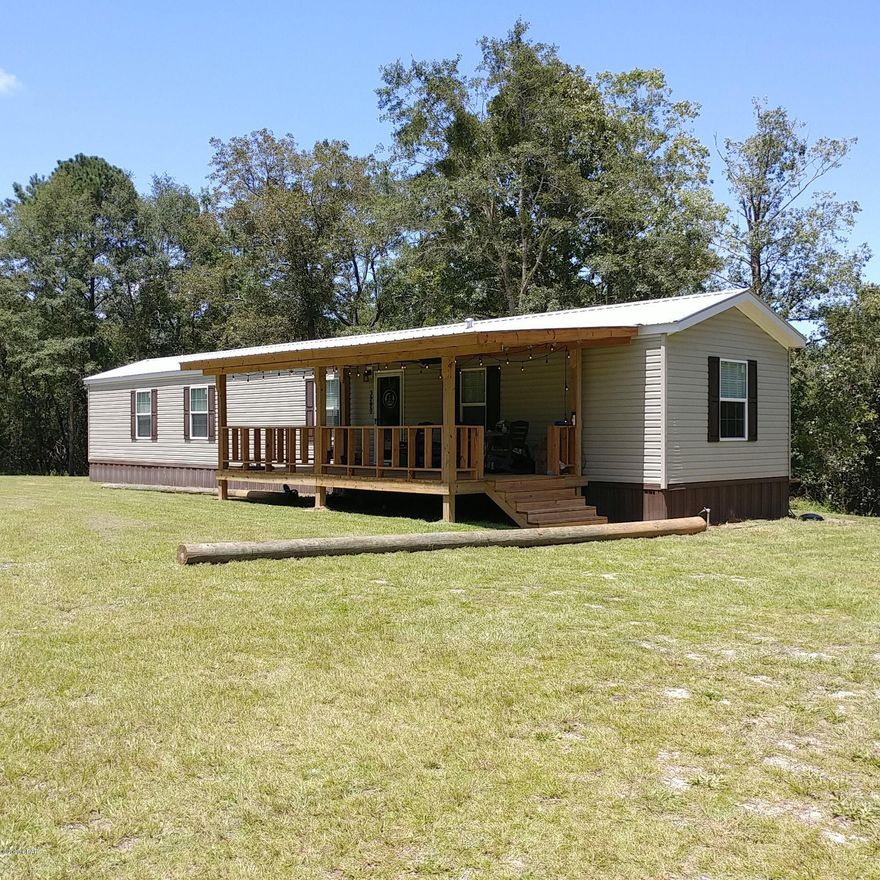 Don't miss out on this immaculate, like-new 3-bedroom, 2-bath mobile home. Located on a paved road only 10 minutes from DeFuniak Springs schools and shopping.  Peaceful, quiet, off the beaten path, not in a flood zone, and no HOA fees. The home is 16'x82' and sits away from the highway on 5 acres with fencing across entire front of lot. Beautiful kitchen comes with stove, refrigerator w/ice maker, and dishwasher.  The master suite includes a large bedroom with attached bath that has a deep-soak tub and separate shower.  Has a nice 12X24 covered porch on the front. There is a sandbox in the yard and a garden area. The yard is 3.5 acres and the rest of the property is wooded around the perimeter for privacy and seclusion.  No close neighbors. Home is simply gorgeous and a must-see !!