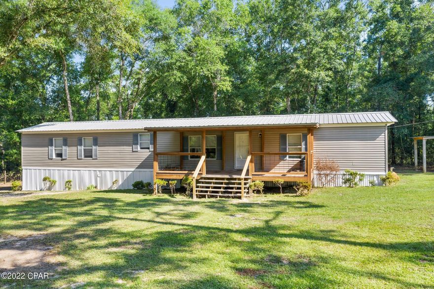 Country living!  Single wide mobile home located on one acre.  Large covered front porch.  Three bedroom, two bathroom home.  Kitchen has a nice amount of cabinets.  Living area has laminate flooring and a fireplace.  Master bedroom has a walk in closet and bathroom has double vanities and extra storage.