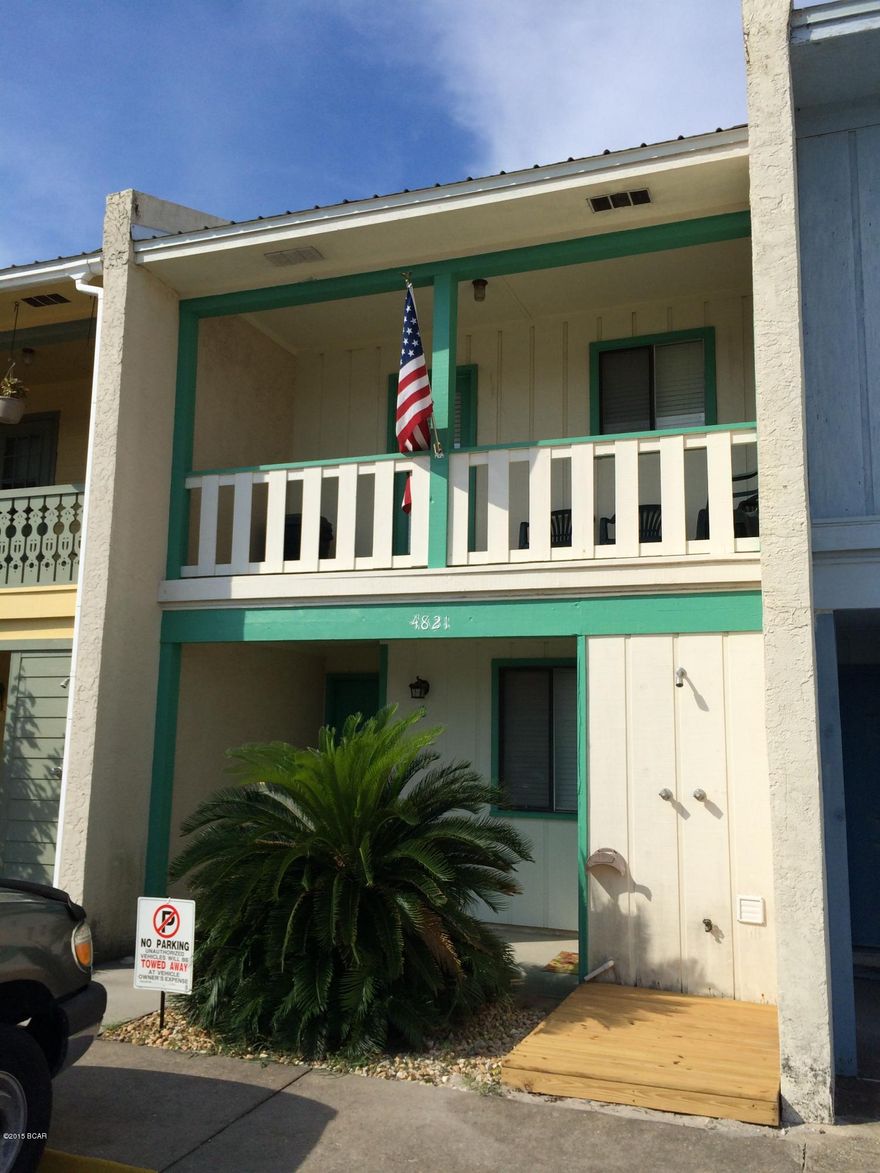 Rare find - 2 bedroom town home with a Gulf View. This home has recently been painted, and features a Gulf view from the upstairs balcony off of the living room, downstairs storage with fenced yard, and outside shower. This home is also very close to Treasure Island Marina.