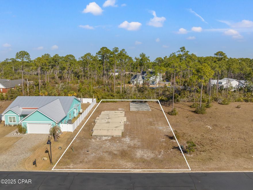 This ready-to-build ¼-acre lot in the sought-after Magnolia Bluff community of Gulf County, Florida, presents a rare opportunity to jumpstart new construction without the usual delays. The property features a pre-existing slab foundation and architectural plans, significantly reducing upfront time and costs. Located just 0.4 miles from pristine public beaches, the lot offers convenient access in a golf cart-friendly neighborhood close to local shops, restaurants, and boat ramps.

The current owner is offering an optional pre-construction package in collaboration with a licensed contractor and reputable lender. Buyers may choose a turnkey land-and-build option (subject to lender approval) or purchase the lot separately and coordinate construction independently using the groundwork already in place. Comprehensive construction documents, including cost estimates for framing, plumbing, and electrical, TDB w/contractor upon choice, along with survey data and architect/engineering contacts upon request.

Located in a federally designated Opportunity Zone, this property offers potential tax advantages and strong investment appeal. Gulf County is known for its stunning beaches, outdoor recreation, and laid-back coastal lifestyle. Nearby towns like Mexico Beach, Port St. Joe, and Cape San Blas offer dining, shopping, and entertainment, while seasonal activities like scalloping draw visitors from across the region. The area also features dog-friendly beaches, Veterans Park, and abundant opportunities for fishing, kayaking, paddleboarding, and birdwatching.

Whether you're an investor seeking a high-potential project or a homeowner ready to build in a peaceful coastal setting, this property is a prime opportunity to own a piece of Florida's rapidly growing 'Forgotten Coast.' Contact your favorite Realtor today for more information.

RV's & 5th Wheels are allowed to be housed in the garage.

Equal Housing Opportunity. All information deemed reliable but not guaranteed. Buyer to verify zoning, building requirements, HOA R&R, and permitting with local authorities.