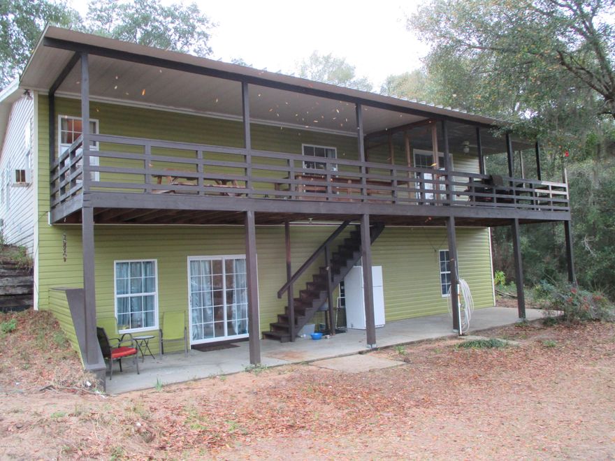 Enjoy the beautiful views of River Pond Lake from this very will maintained two story lake front home.  It is nestled into the sloping shore of the lake which results in a ground level entry on the front of the home and spectacular high views of the lake from the rear.  The first floor includes the kitchen, dining and family rooms and a second bath.  It also includes the master bedroom and bath. The lower level floor includes two bedrooms, a third bath and a very large bonus room perfect for a pool table, man cave, play room or 4th bedroom.  The home has a 10' x 50' covered front porch on the front and another 10' x 50' covered porch overlooking the lake from the rear.  The property includes fenced pasture, round pen, a 5 stall barn with tack room and a 21' x 24' storage building. It also includes a 15' x 38' covered RV parking space complete with water, power and sewer connections.  Call your realtor today and schedule a visit.  Sizes and measurements are approximate.  Verify if important.