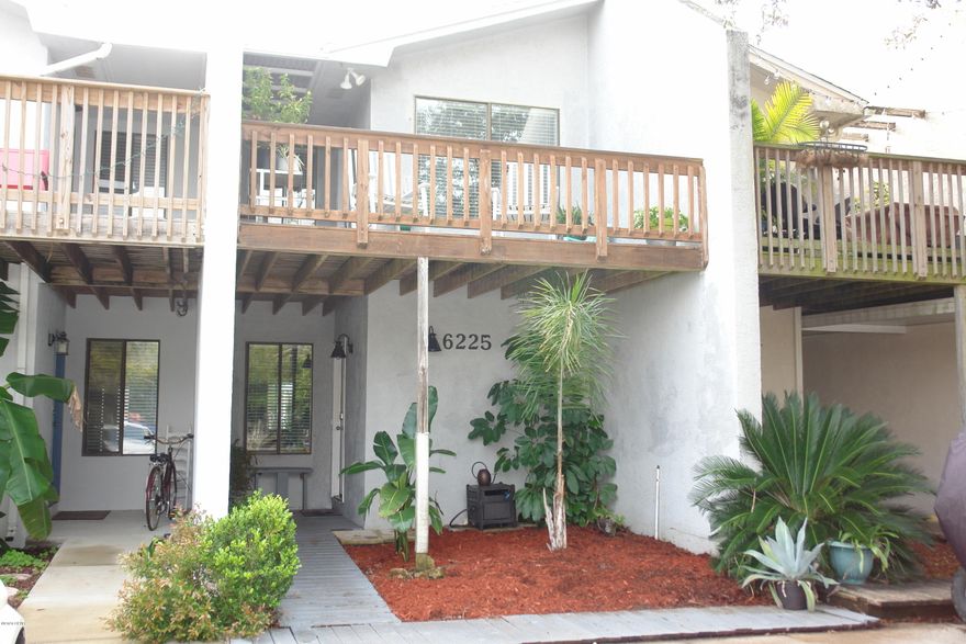 BACK ON THE MARKET! Buyer financing fell through! BRAND NEW ROOF!  This amazing townhome has more outside living space than most houses. This home features two Master Bedrooms, two dens with one that could easily be turned into another bedroom. Two large covered porches and a great privacy fenced back yard with new decking and landscaping. This home would be a perfect primary residence, beach home, or short term rental as its comes fully equipped & furnished! This unit has a view of the lagoon and a very short walk to boat ramps. Bring your clothes and move on in! No HOA fees!