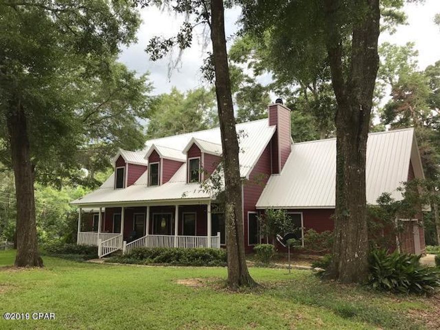 FABULOUS WATERFRONT 4BEDROOM/3.5BATH HOME ON 5.18 ACRES on Merritt's Mill Pond, a 202-acre spring fed reservoir known for trophy shellcracker & bass fishing, adorned w/cypress trees draped with Spanish moss, oak leaf hydrangea & ferns dotting the limestone rocks on the banks. This 2story home boasts spacious rooms, w/recent improvements that include glassed-in sunroom w/skylights, metal roof, flooring, HVAC unit, hot water heater, house wiring for generator, & solar panel operated whole house attic fans. The exterior has been completely redone with Hardie Board & river stone foundation façade. The property includes a 40'x36'x14' boat barn with plenty of parking & room for much more. Home has damage from Hurricane Michael, REALTORS, please see Agent to Agent remarks for ''As Is'' price