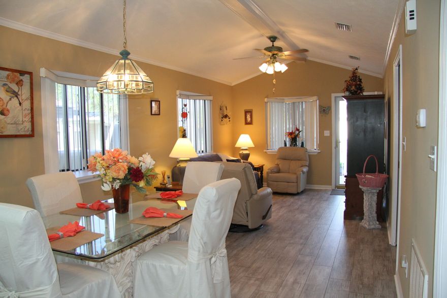 You'll LOVE this charming 3 bedroom cottage located in the amazing community of Venture Out. A site built home, created in 1996, amid a community filled with resort amenities and low HOA fees. This is a perfect second home or vacation rental with BOTH a dedicated Beach and GULF access via Grand Lagoon, two pools, kids play area, picnic tables, grills and much more. A perfect family vacation. This home is in great shape; the NEW wood look tile floors in the main living area are GORGEOUS! The third bedroom/bonus room will help garner more income! This home even has an attic with pull down stairs for extra storage, as well as storage under the home for bikes and beach accessories. This home is also equipped with a whole house water filtration system. Don't wait to see this updated GEM!