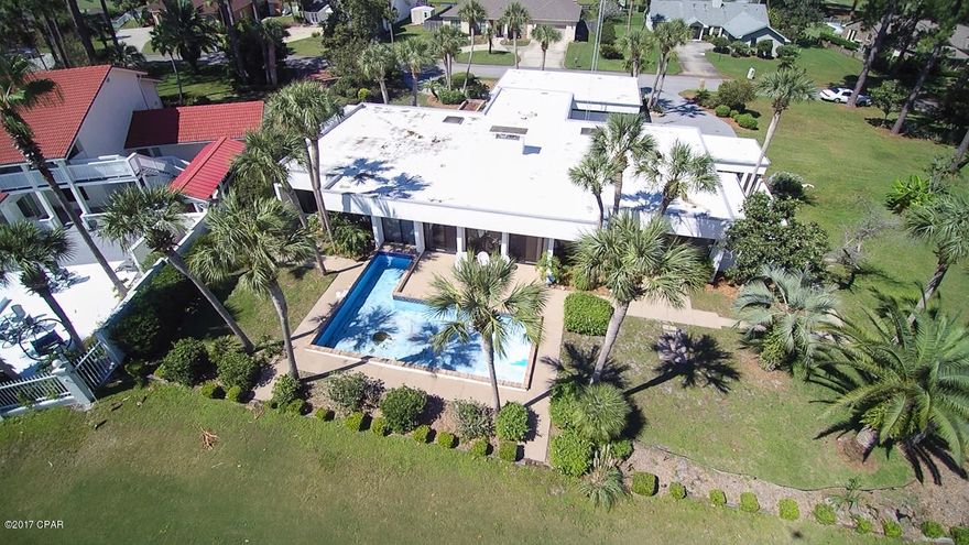 This unique home on the Holiday Golf Course (Colony Club) includes an additional buildable lot and is offered with NO HOA. It is located less than 10 minutes’ drive from the beautiful sugar white sands of Panama City Beach, where you can also enjoy great bars, restaurants, entertainment and shopping at Pier Park and across the waterfront. The active resident will also enjoy the neighborhood's access to Gayle’s Trails, which offer 19.5 miles for biking, walking or jogging.



Built by architect and contractor Jim Chapman as his personal home, this spacious property boasts unique design features that set it apart from the rest. Inside you will find an open floor plan concept perfect for family life or entertaining.  The large living room has built-in bookcases, floor-to-ceiling windows with with sliding doors overlooking the golf course, and garden atrium features at both corners of the room. The master bedroom has a built-in dresser with roll-out shelves and two walk-in closets. The master bath is truly luxurious, with two toilets and sinks, a well-lit vanity, a walk-in shower, a Jacuzzi and a sauna. Two additional bedrooms share a further full bathroom. The master and second bedroom each feature an enclosed patio, perfect for enjoying the sun in privacy or for children to play in safety.
 
The kitchen/diner features an island with a breakfast bar, a large modern fridge/freezer, plenty of counter and cupboard space and room for a large dining table. Off the kitchen sits a small room great for use as an office or music room. There is a spacious laundry room with a sink and plenty of storage space. The laundry room connects to a double garage with a further home office/workshop inside of it, and a large pantry for further storage.
 
Outside you will find fully landscaped grounds, a large circular drive with plenty of parking space, a pool, and most importantly a large, cleared empty lot with loads of potential. This could be built on or used for extra privacy and outdoor space. Viewing is recommended of this one-of-a-kind property.