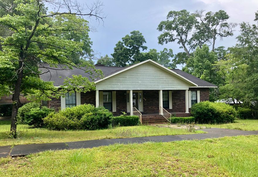 Right in the City Limits of Bonifay, you will find this beautiful large brick home with a fireplace that offer's 3 bedrooms, 2 Baths nestled under 2017 sq. ft.  This home is perfect for entertaining and is within walking distance to many of the shops and restaurants.  Oversized carport on a concrete slab in the back of the house, making entry to the house quick and easy.  Large backyard with a workshop.  Some TLC is needed. Age, SF lot and room sizes are approximate. Please verify if important.