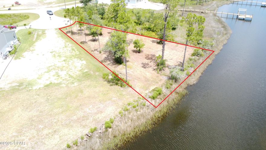 A spectacular deep water homesite in the desirable Laird Point! A massive 138ft on the water and excellent year-round water depths. Can easily accommodate large cruisers and fishing vessels. Only s short boat dock is needed. No low bridges to block your path to the Gulf of Mexico and several full-service marinas in route for fuel and ice. At .381 of an acre, there is plenty of space to build your dream home. A nice open water view from this lot.  No preset time to build so you can lock in your spot now and build when the time is right. Laird Point is gated waterfront peninsula offering ribbon curbed streets and underground city utilities. Amenities include RV/Boat storage, a tennis court, a pickleball court, and a basketball court. A beautiful community with custom home throughout. Private and off the beaten path, but still great proximity to Panama City Beach and Mexico Beach.