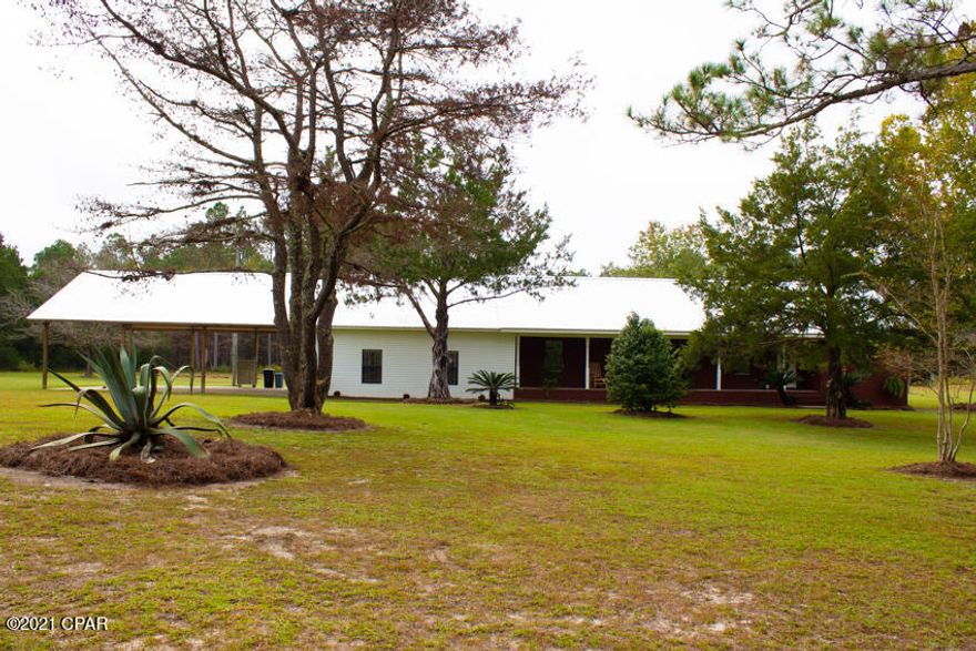 This home has it all!  Peaceful, quiet setting in the country with plenty of privacy yet only 10 minutes to town.  Landscaped 5 acres is almost completely fenced on perimeter and has a chain link fenced yard perfect for pets.  This beautiful red brick home with metal roof is neat as a pin.  Home has almost new roof, HVAC unit, roof, carpet that looks brand new, vinyl plank floor covering, fresh paint and much more.  New 200 amp electrical panel. Master bedroom with large walk in closet and the master bath is a dream with a large jacuzzi jet tub plus shower. The huge oversized den has 780+ SF, could be used as bedroom, game room, den, or mother in law suite.  This room has a bar and a full bath.  Carport has room for 6 cars or an RV plus 4 cars.  An RV/trailer hookup on property.