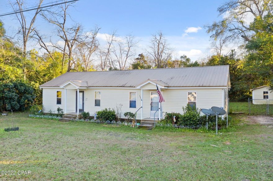 Calling all investors!  This four  bedroom, two bathroom home is located in the Graceville city limits.    With some TLC this home could be a stunner.  The home features vinyl siding and a metal roof.  The back yard is fenced.  Home currently has an interior layout similar to that of a duplex with a common living area and one central HVAC unit.  The possibilities are endless!