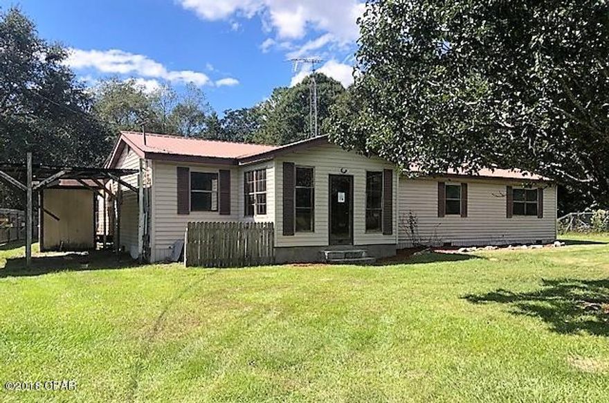 This vinyl siding home is in the country on a large lot.  It has 3 bedrooms 2 and 1/2 baths.  There is a large living room, a kitchen with breakfast area and a dining room.  It has great potential as it needs some repairs and updates.  It has an attached carport and there is a 15x14 barn and another building just right for a workshop.  There is some privacy fencing also.