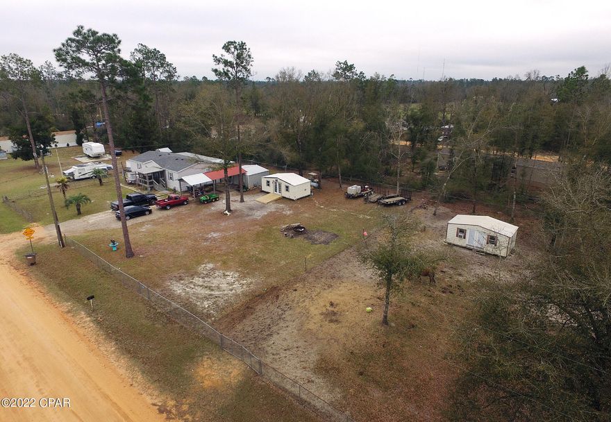 Get 3 for 1 $219,977 includes all 3!! The main property with the home on it is in between the two lots! This 3 bed, 2 bath home has screened in front porch, a screened in patio in the back with handicap ramp! The covered parking area can park 2 vehicles and the storage building has electricity and A/C. The property has 3 storage buildings that have electricity. Both of the vacant lots have electricity and one already has a septic tank. Concrete pads are on one of the lots where 2 houses were and are ready for an RV or home and water and septic tank is already there. The home at 12206 is updated with newer appliances, LVP flooring, and an office that can easily be used as a 4th bed or bunk room. Located only 2 blocks off Hwy 231 and plans are to pave Pinecrest Rd soon. Come see this ASAP!!