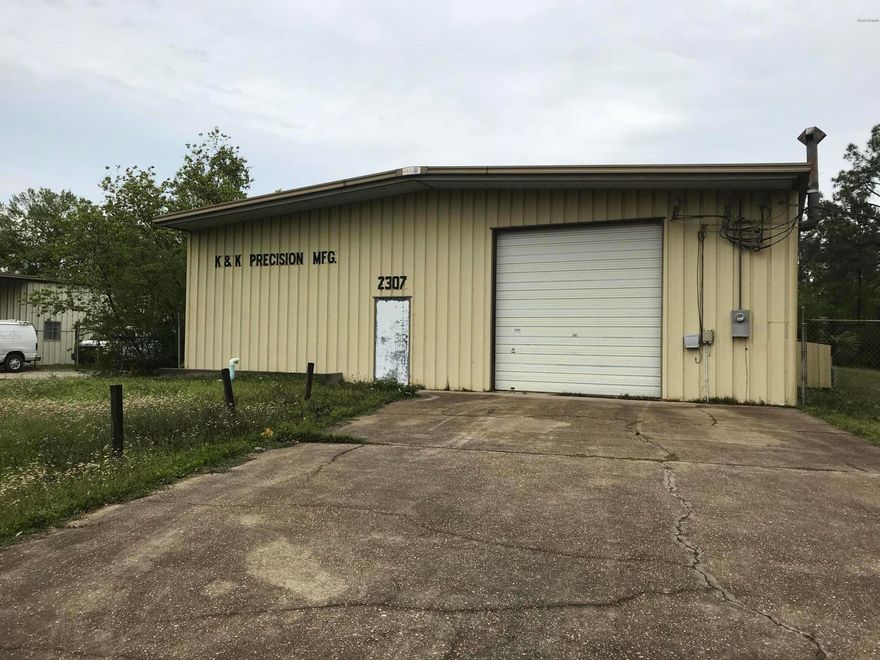 Conveniently located to major highways in Panama City, this 7200 sq. ft. fully insulated building is ready for a new owner. There is 6400 sq. ft. of work/warehouse space split into one large area and one smaller. The smaller area has a built in raised platform for additional storage. Also in the small area is a well ventilated built in paint spray booth. The building is accessable through front and back 12 ft. overhead roll up doors and two service entry doors. Electrical service is 600 AMP, 3 phase. There is a small office area and a larger office/break area with a kitchen and bathroom. The water and sewer is provided by a county source. Owner operated a CNC machine shop in the building until 2009.
